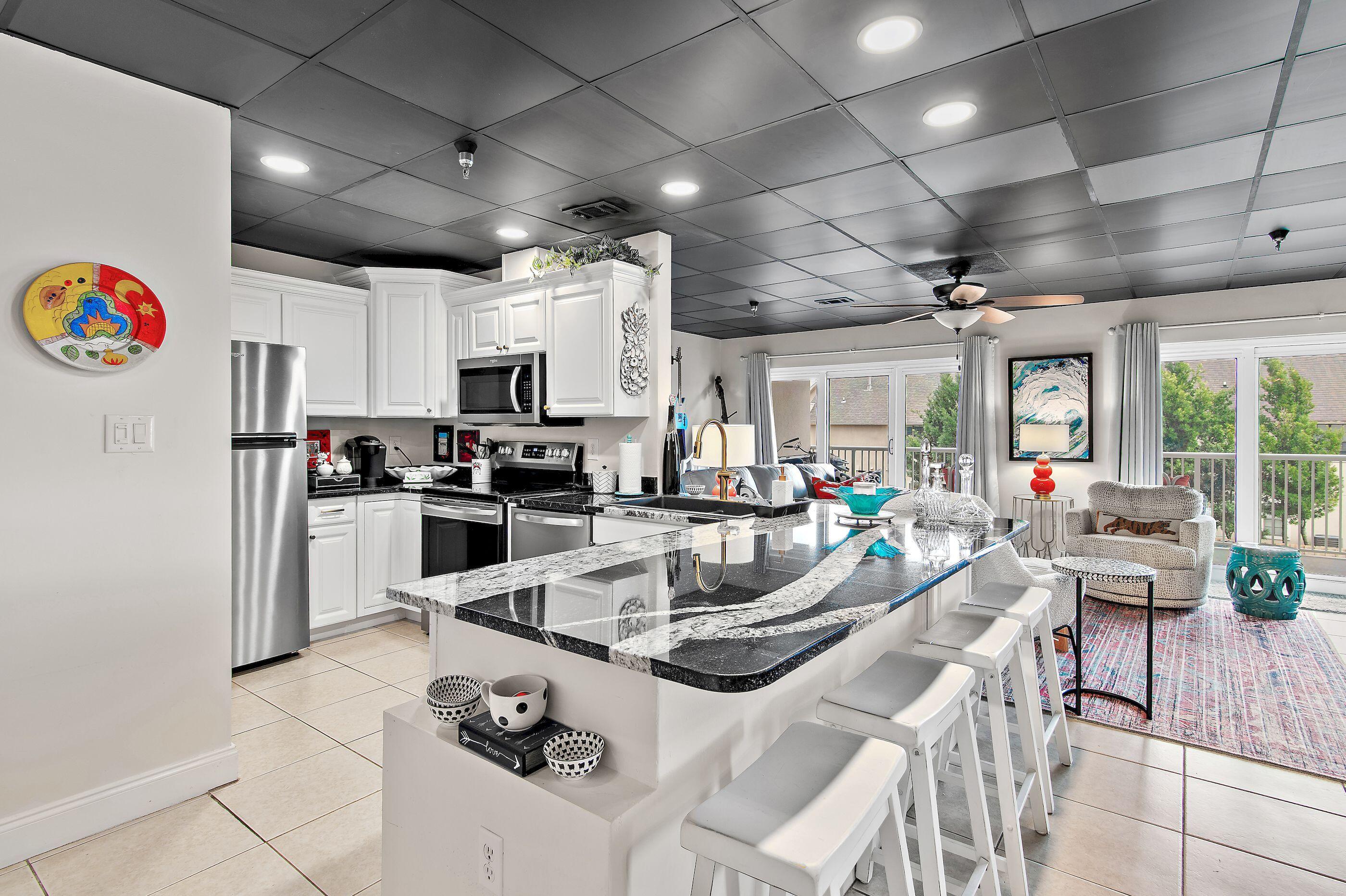 197 Durango Road, Unit 2B Destin, FL 32541 - Photo 10 of 29 a kitchen with a sink appliances and cabinets