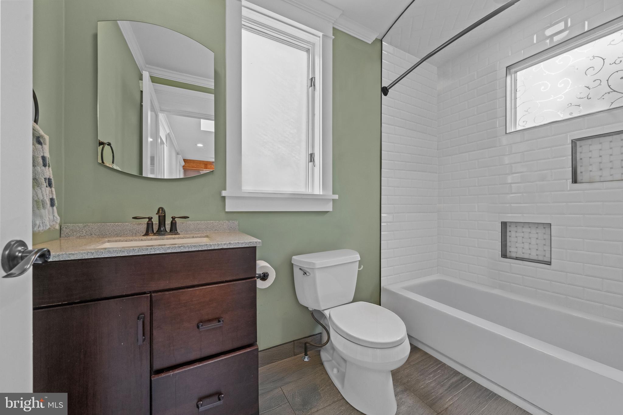 614 Maple Avenue Haddonfield, NJ 08033 - Photo 15 of 42 a bathroom with a toilet a sink a mirror a bathtub and vanity