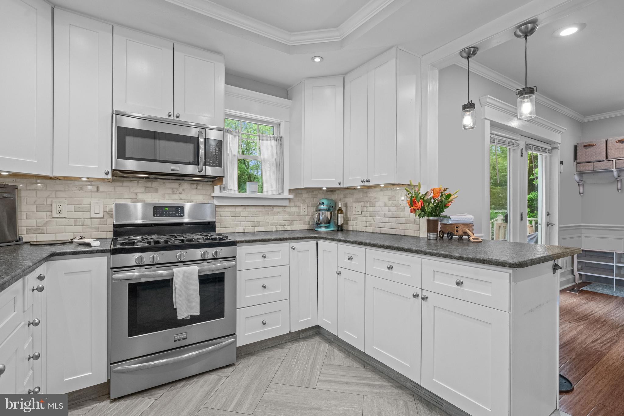 614 Maple Avenue Haddonfield, NJ 08033 - Photo 23 of 42 a kitchen with granite countertop white cabinets white stainless steel appliances and sink