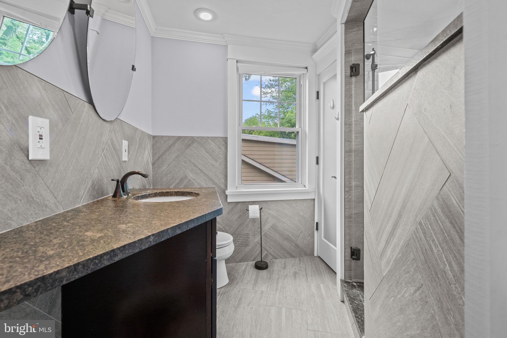 614 Maple Avenue Haddonfield, NJ 08033 - Photo 29 of 42 a bathroom with a granite countertop sink and a mirror