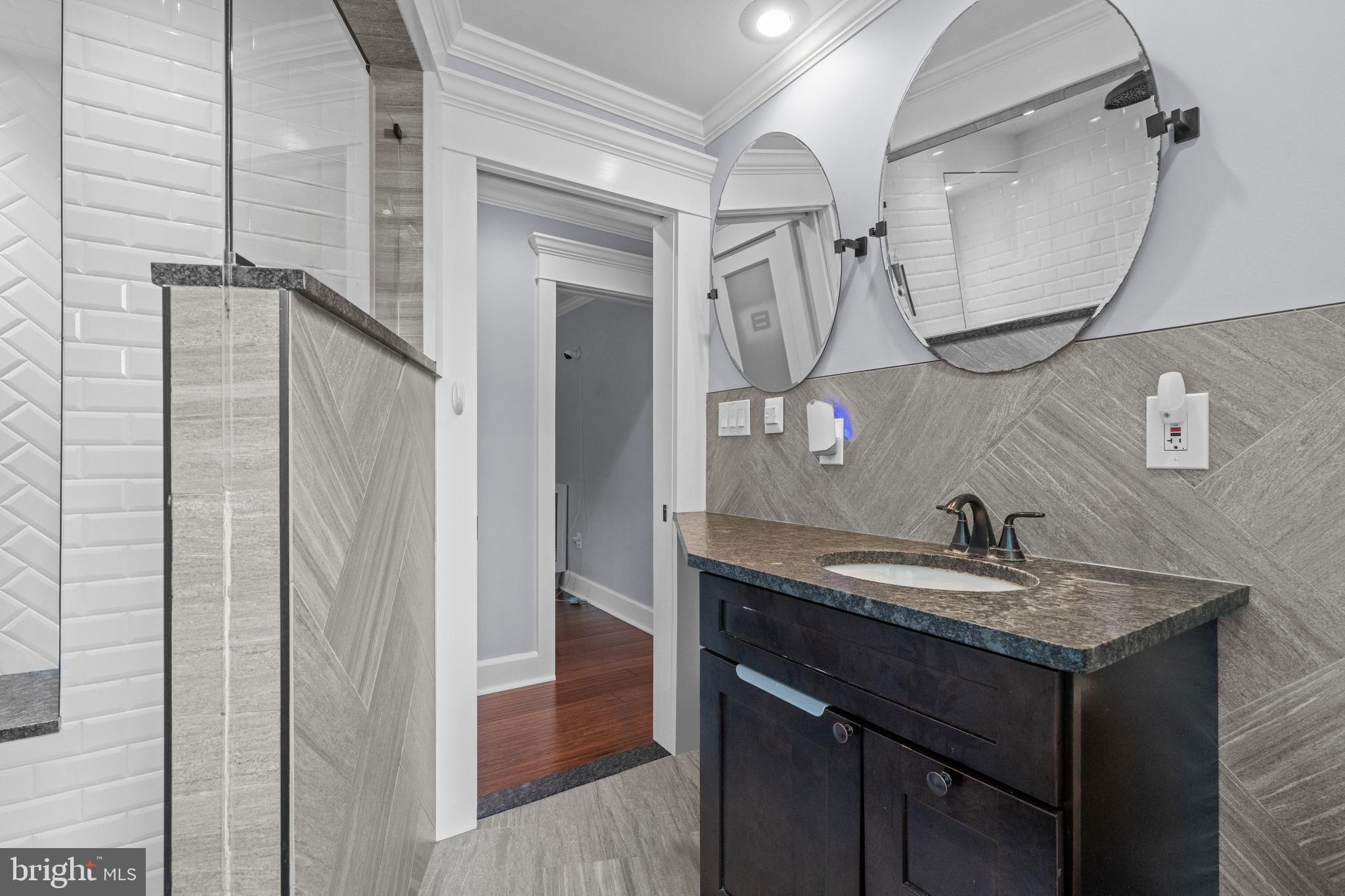 614 Maple Avenue Haddonfield, NJ 08033 - Photo 30 of 42 a bathroom with a granite countertop sink a mirror and shower
