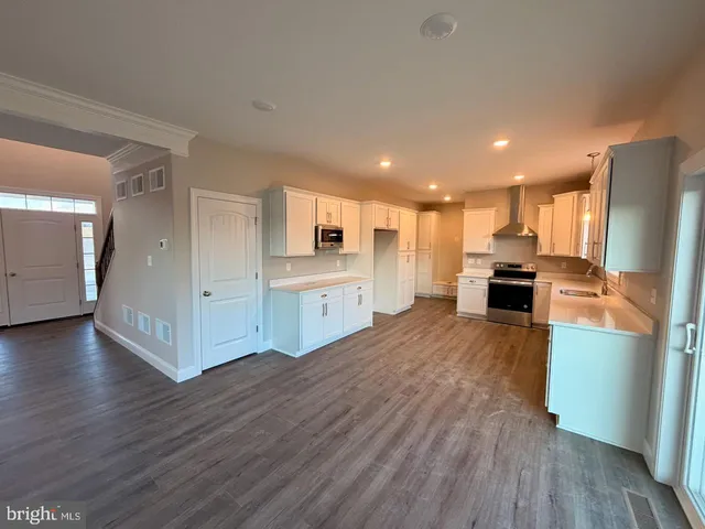 a view of kitchen with refrigerator microwave and stove