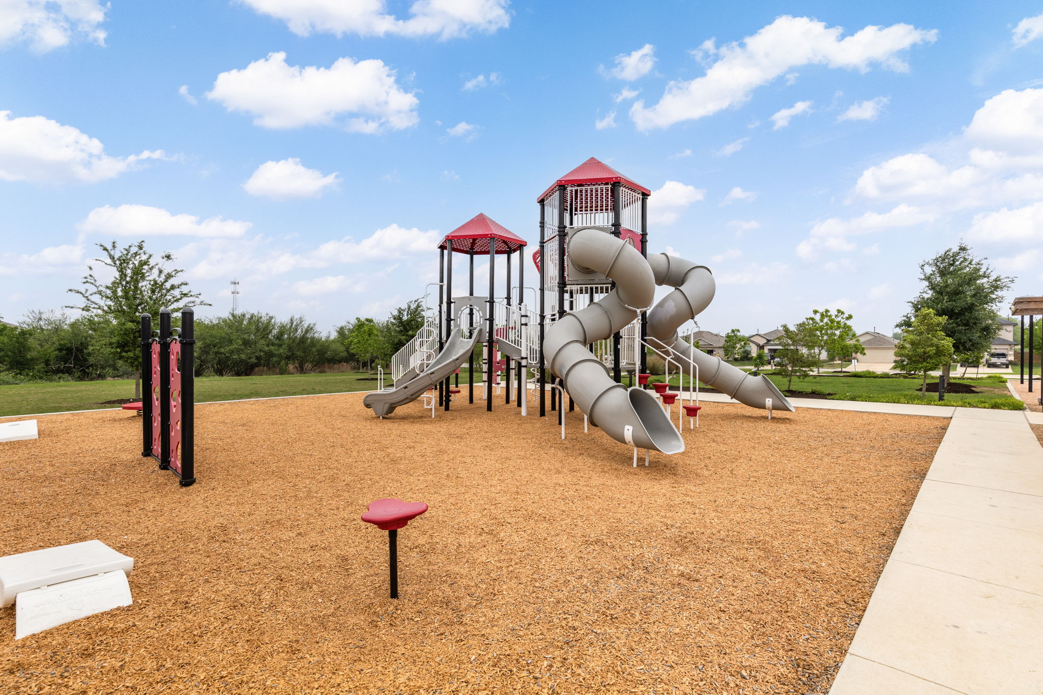281 Jayden Drive Kyle, TX 78640 - Photo 36 of 36 Community playground featuring multiple slides, climbing structures, and protective wood chip surfacing