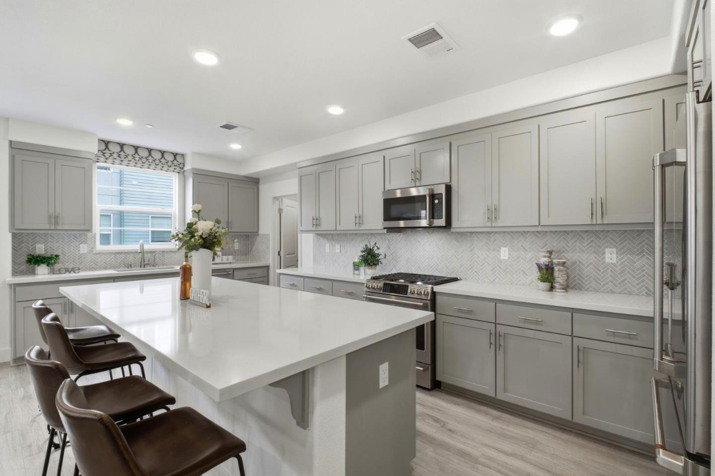385 Line Street Hayward, CA 94544 - Photo 12 of 38 a kitchen with kitchen island white cabinets and appliances