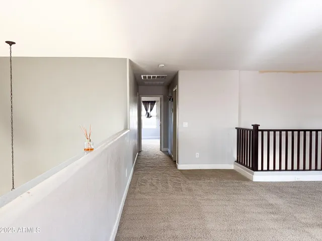 a view of a hallway with staircase