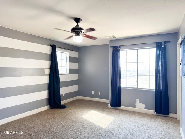 a close view of walk in closet with a bathroom