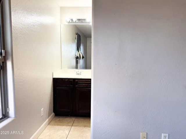 an empty room with a window and a ceiling fan