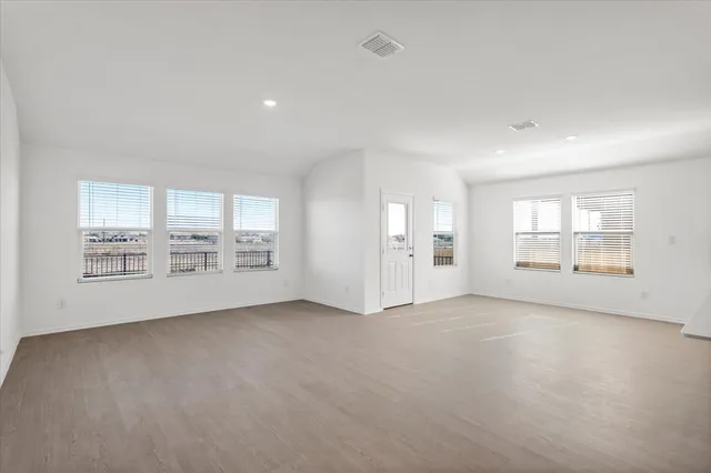 a kitchen with stainless steel appliances a refrigerator sink and white cabinets