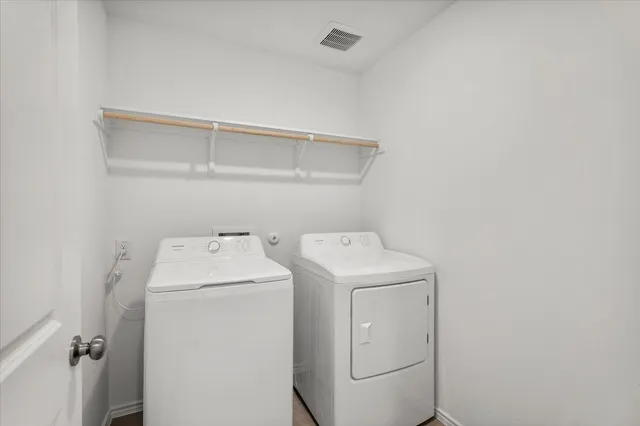 a kitchen with refrigerator and cabinets