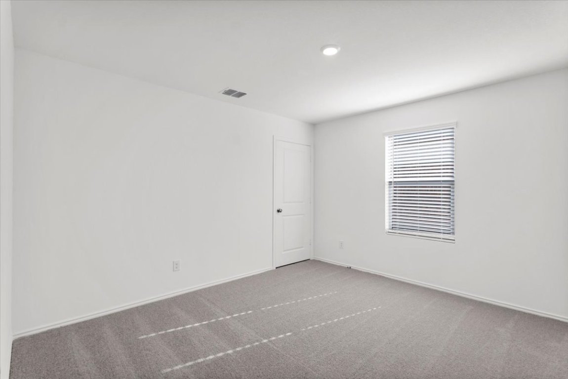 221 Rodney Boat Road Kyle, TX 78640 - Photo 18 of 33 Unfurnished room with carpet and recessed lighting