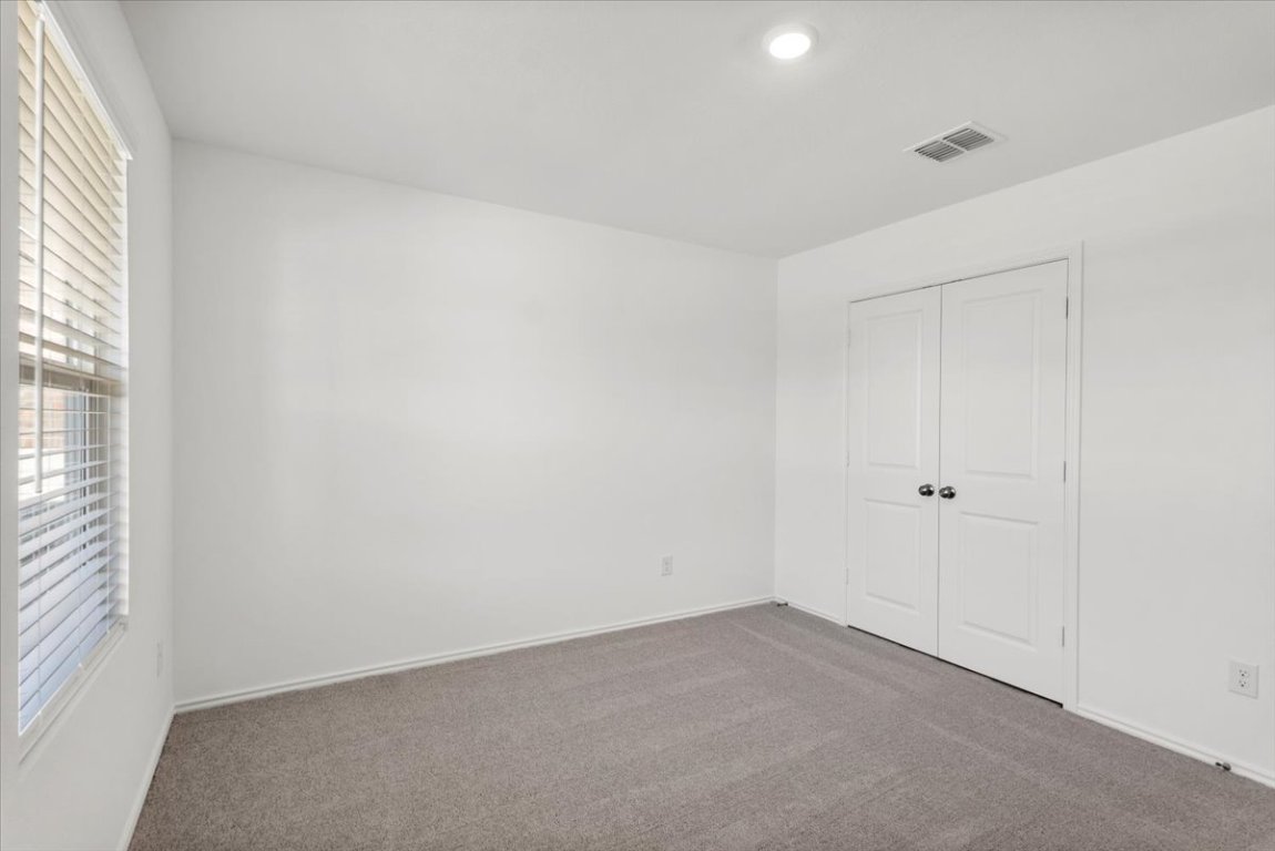 221 Rodney Boat Road Kyle, TX 78640 - Photo 22 of 33 Unfurnished bedroom featuring carpet flooring and a closet