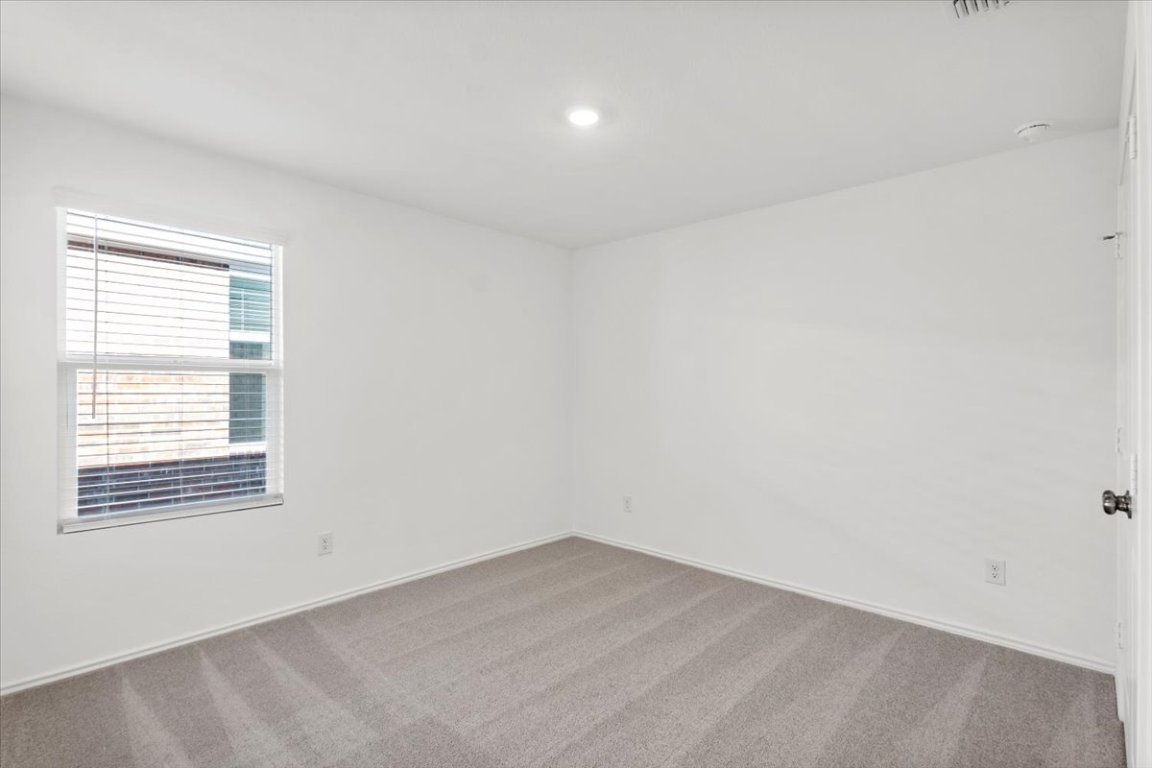 221 Rodney Boat Road Kyle, TX 78640 - Photo 24 of 33 Empty room featuring carpet flooring and recessed lighting