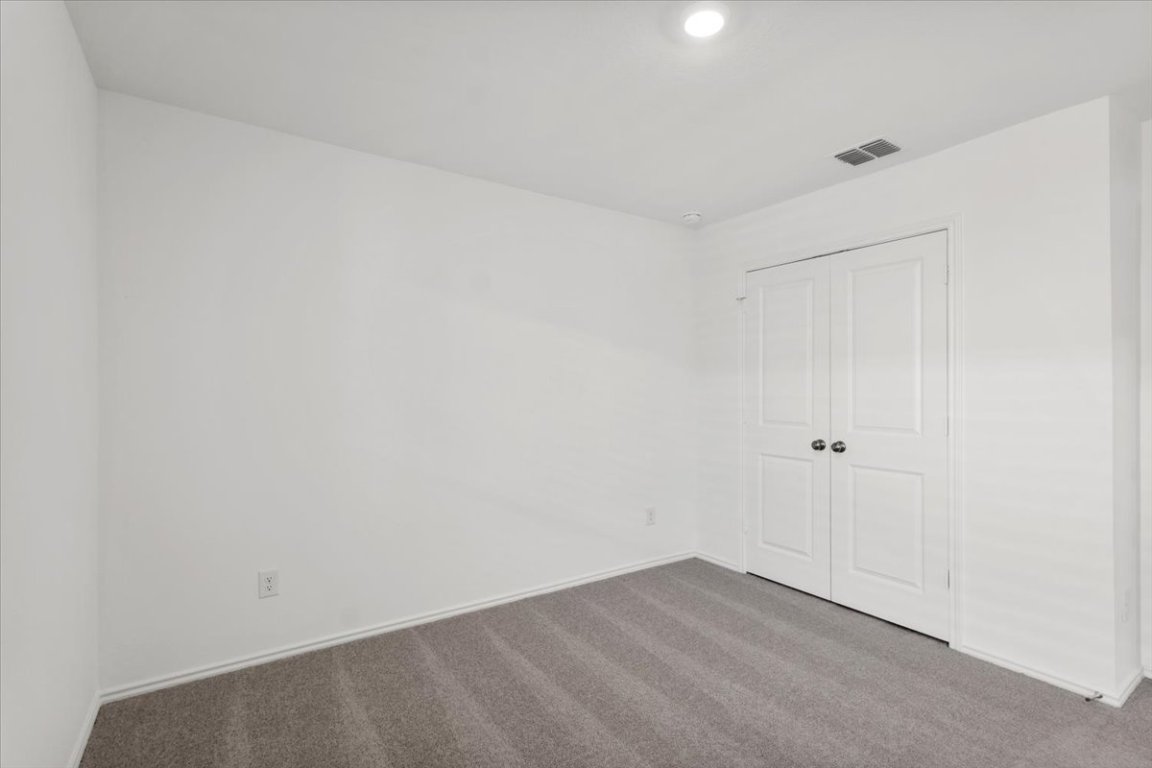 221 Rodney Boat Road Kyle, TX 78640 - Photo 25 of 33 Unfurnished bedroom featuring carpet floors and a closet
