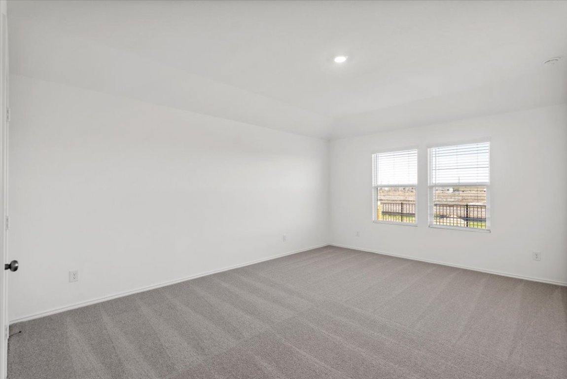 221 Rodney Boat Road Kyle, TX 78640 - Photo 26 of 33 Carpeted spare room featuring baseboards and recessed lighting