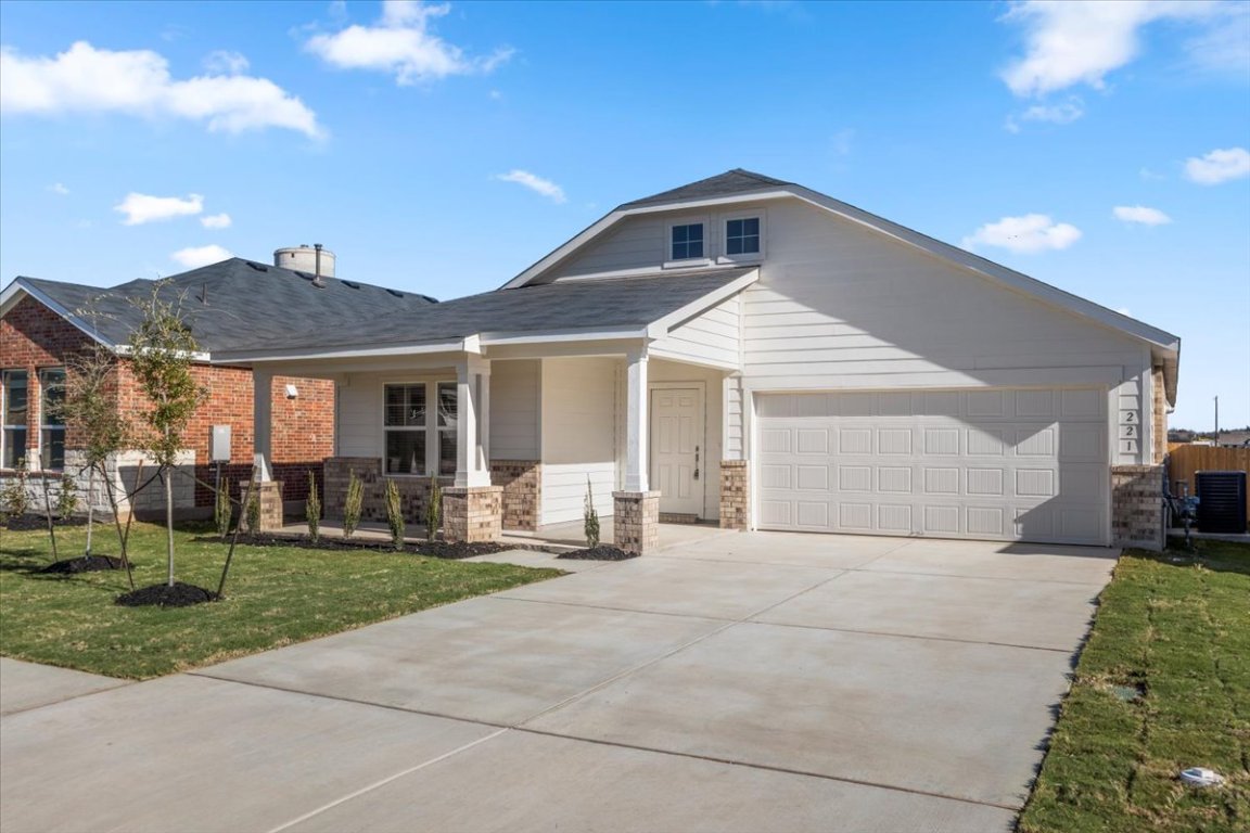 221 Rodney Boat Road Kyle, TX 78640 - Photo 3 of 33 View of front facade featuring covered porch, driveway, and an attached garage