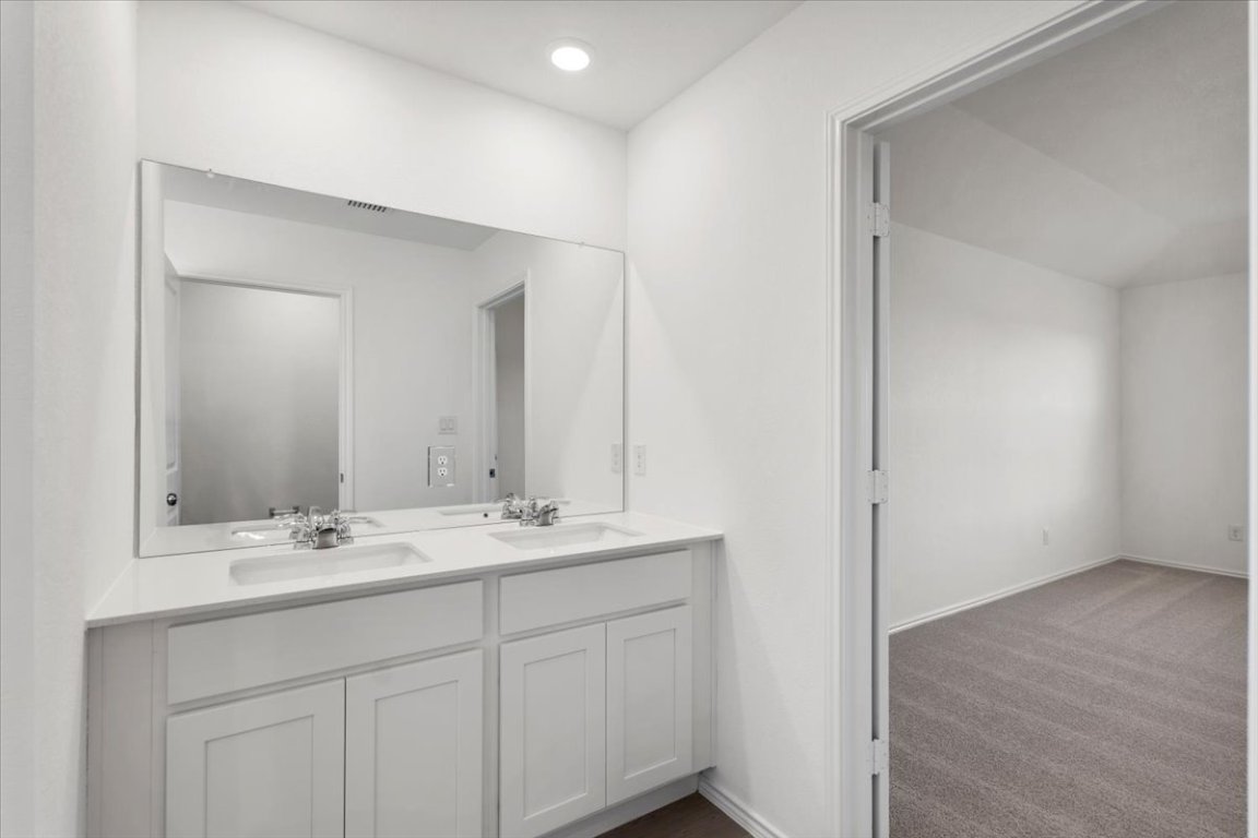 221 Rodney Boat Road Kyle, TX 78640 - Photo 29 of 33 Full bath featuring dark carpet and double vanity