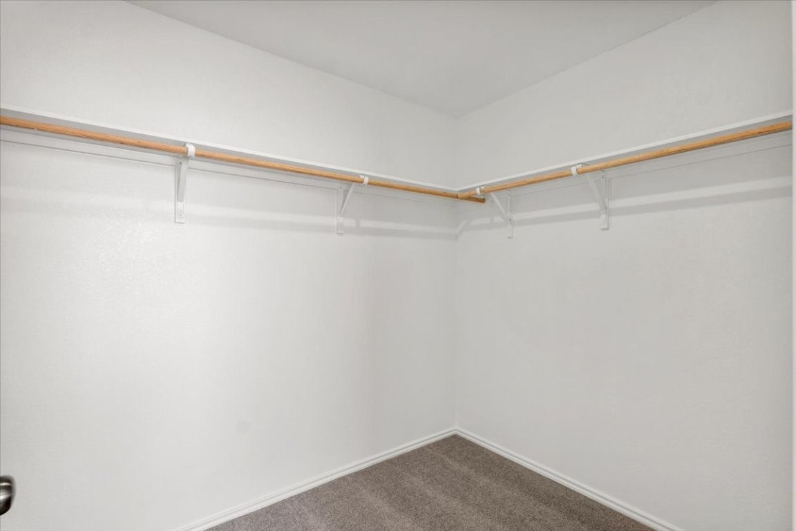 221 Rodney Boat Road Kyle, TX 78640 - Photo 30 of 33 Spacious closet featuring dark carpet