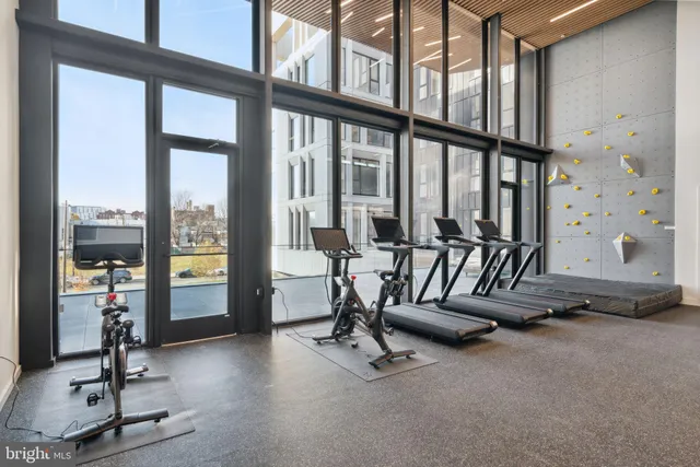a living room with patio furniture and a large window