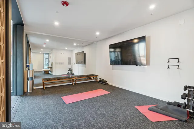 a view of a room with wooden floor and furniture