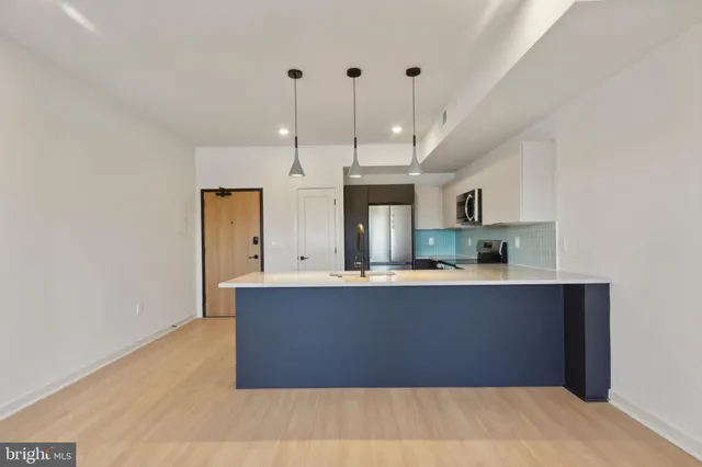a kitchen with a sink and a mirror