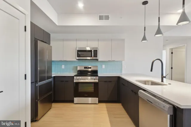 a view of a kitchen with a sink and window