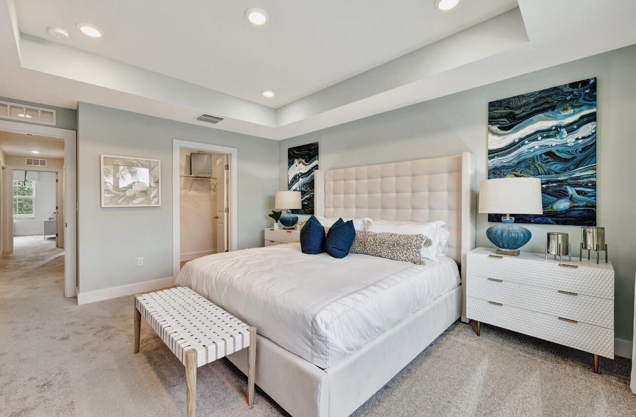 608 Waters Edge Lane, Unit 2202 Port St. Lucie, FL 34983 - Photo 13 of 19 a bedroom with a bed and a dresser