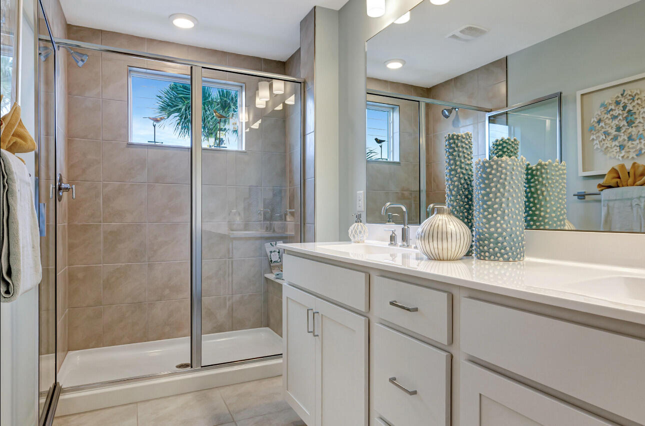 608 Waters Edge Lane, Unit 2202 Port St. Lucie, FL 34983 - Photo 16 of 19 a bathroom with a shower sink and mirror