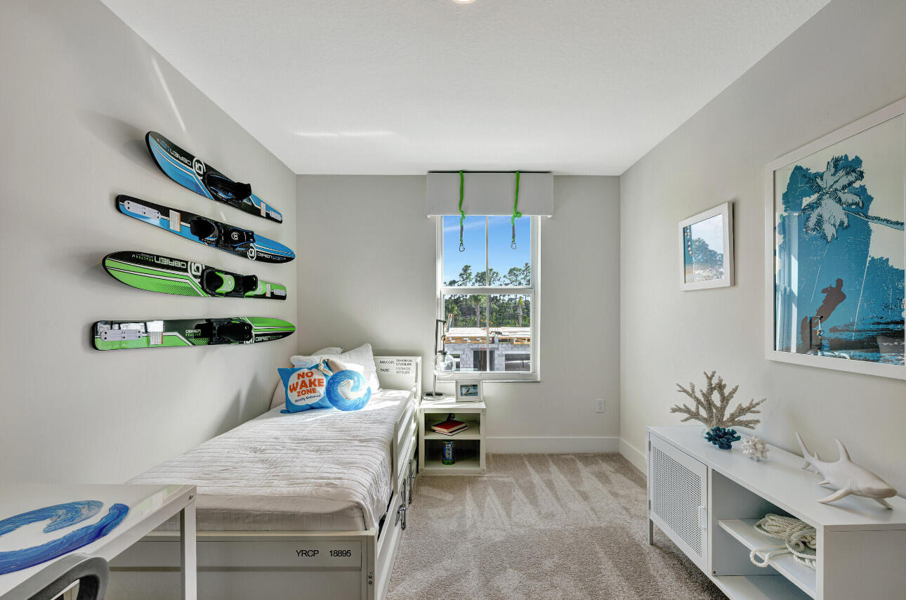 608 Waters Edge Lane, Unit 2202 Port St. Lucie, FL 34983 - Photo 18 of 19 a bedroom with a bed and a window