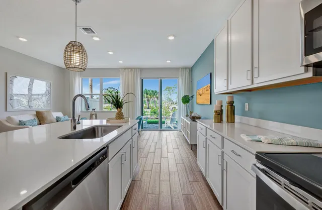 a kitchen with granite countertop a stove and a sink