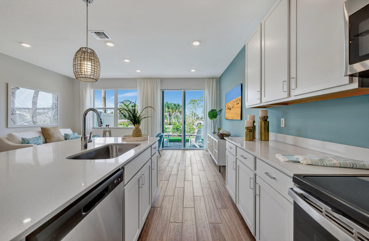 608 Waters Edge Lane, Unit 2202 Port St. Lucie, FL 34983 - Photo 5 of 19 a kitchen with granite countertop a stove and a sink
