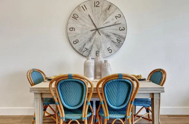 a view of dining area with chandelier fan and wooden floor