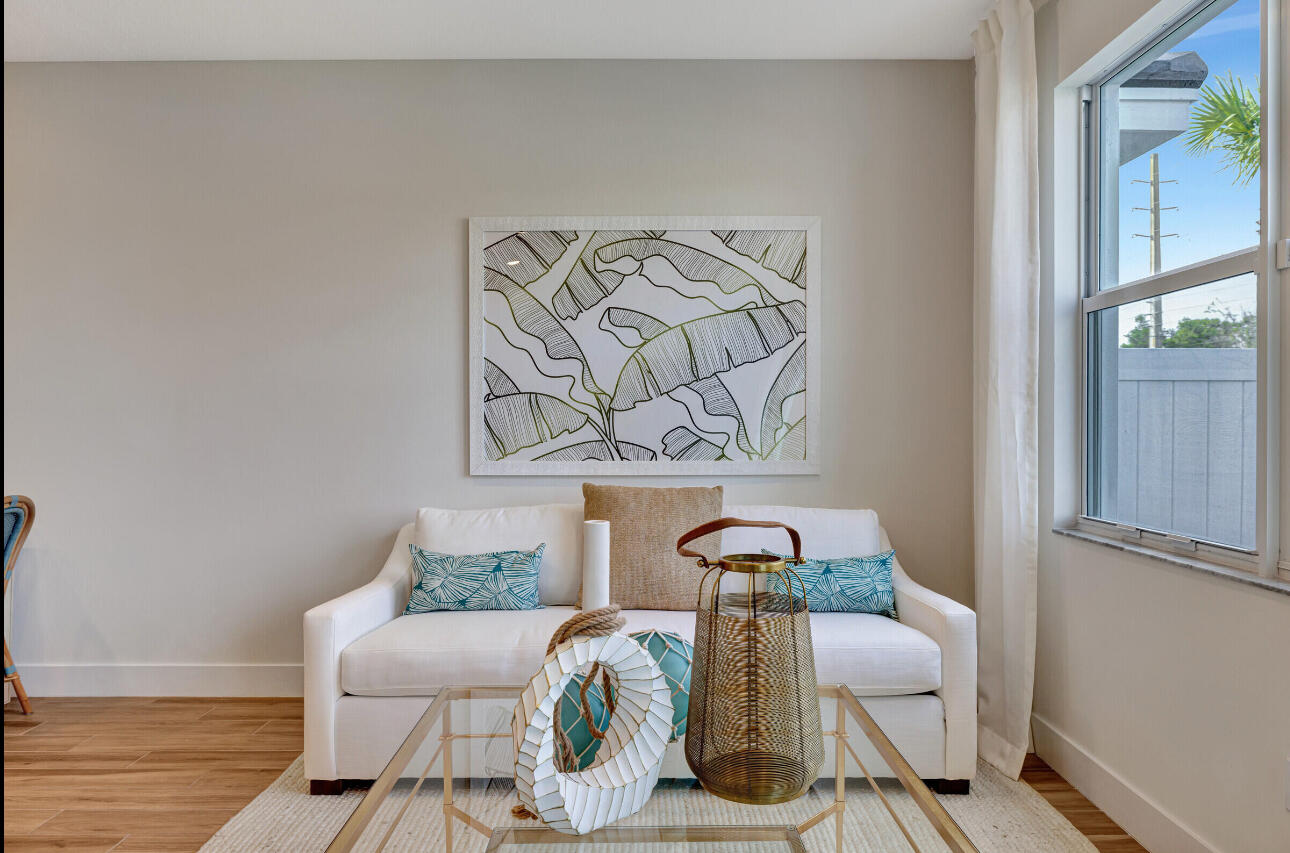 608 Waters Edge Lane, Unit 2202 Port St. Lucie, FL 34983 - Photo 7 of 19 a view of a dining room with furniture and wooden floor