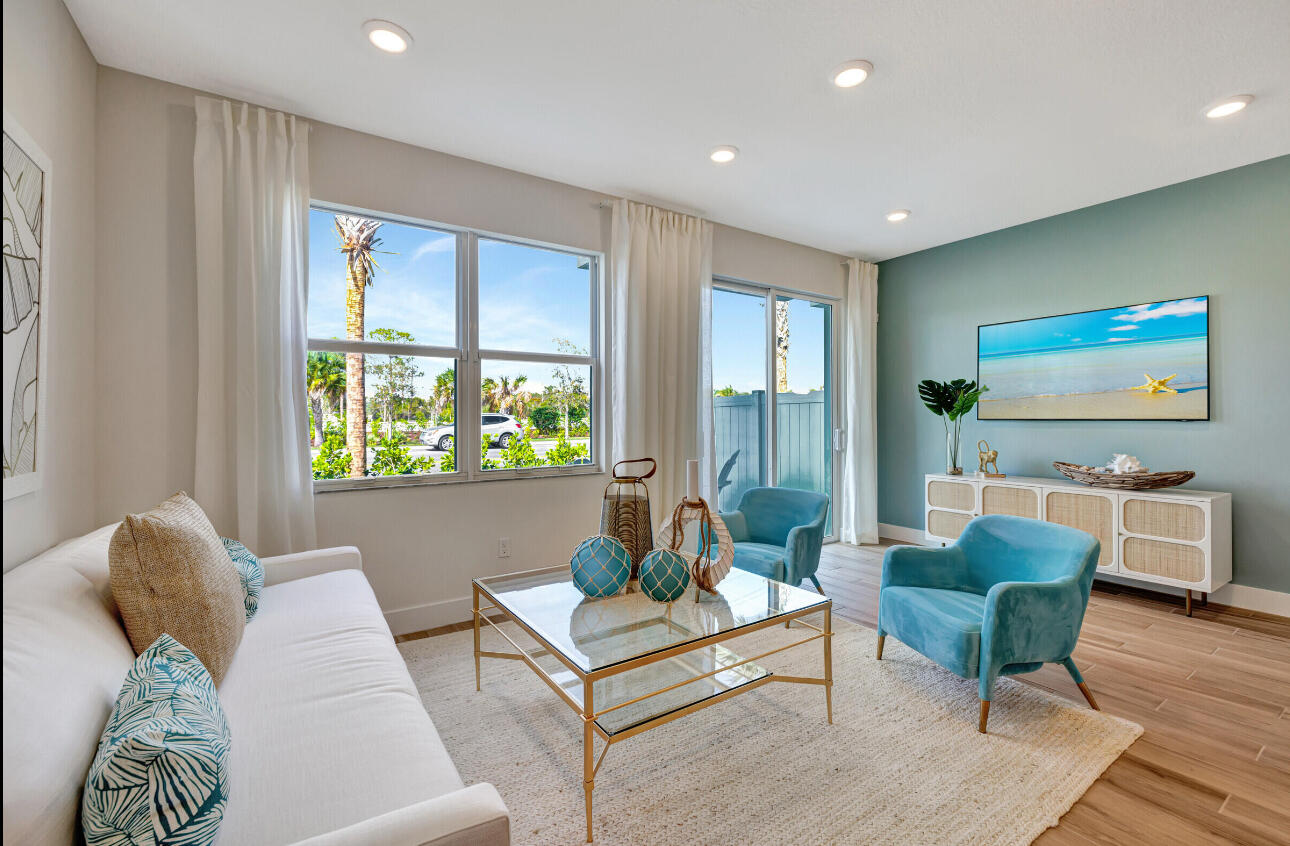 608 Waters Edge Lane, Unit 2202 Port St. Lucie, FL 34983 - Photo 8 of 19 a living room with furniture and a large window