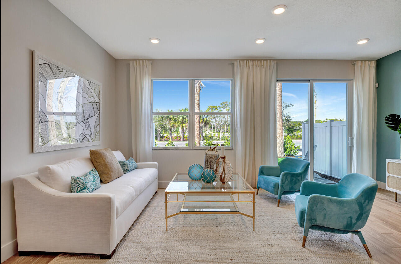 608 Waters Edge Lane, Unit 2202 Port St. Lucie, FL 34983 - Photo 9 of 19 a living room with furniture and a large window