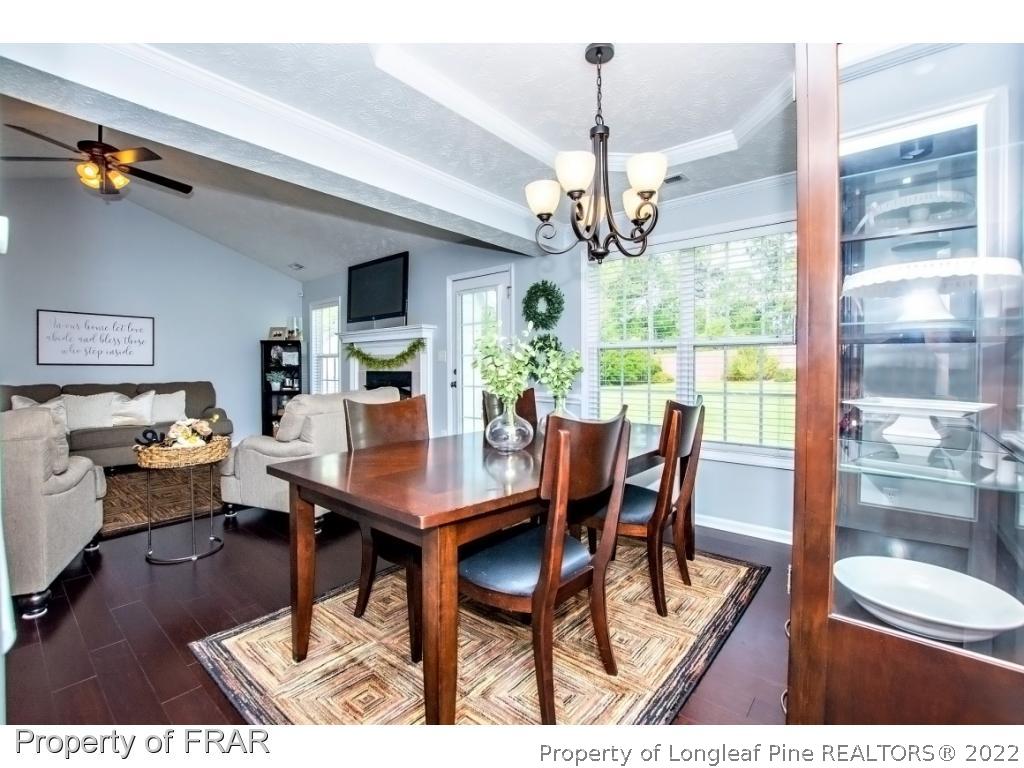 5720 Spreading Branch Road Hope Mills, NC 28348 - Photo 11 of 36 a view of a dining room with furniture window and wooden floor