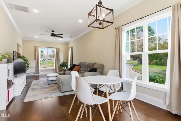 a view of a dining room with furniture wooden floor and chandelier