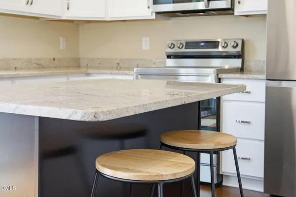 a kitchen with stainless steel appliances a refrigerator stove and microwave