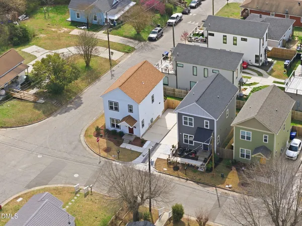 an aerial view of a house with a yard