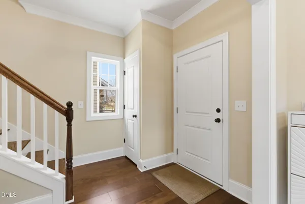 a view of entryway and hall with wooden floor