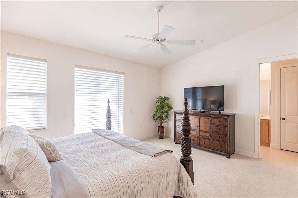 572 11th Avenue South, Unit 2 Naples, FL 34102 - Photo 15 of 28 a bedroom with a bed and a flat screen tv