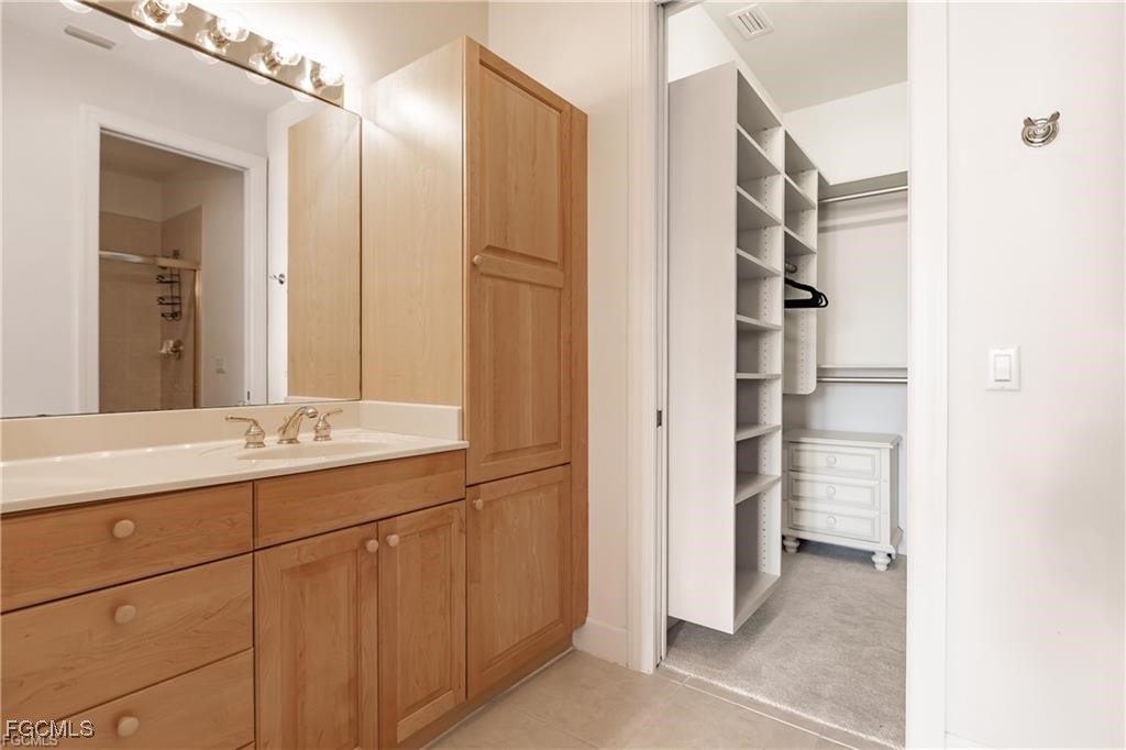 572 11th Avenue South, Unit 2 Naples, FL 34102 - Photo 16 of 28 a bathroom with a double vanity sink and a mirror