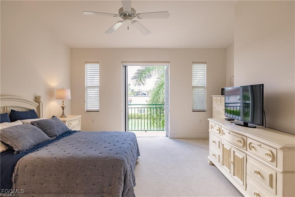 572 11th Avenue South, Unit 2 Naples, FL 34102 - Photo 17 of 28 a bedroom with a bed and a flat screen television