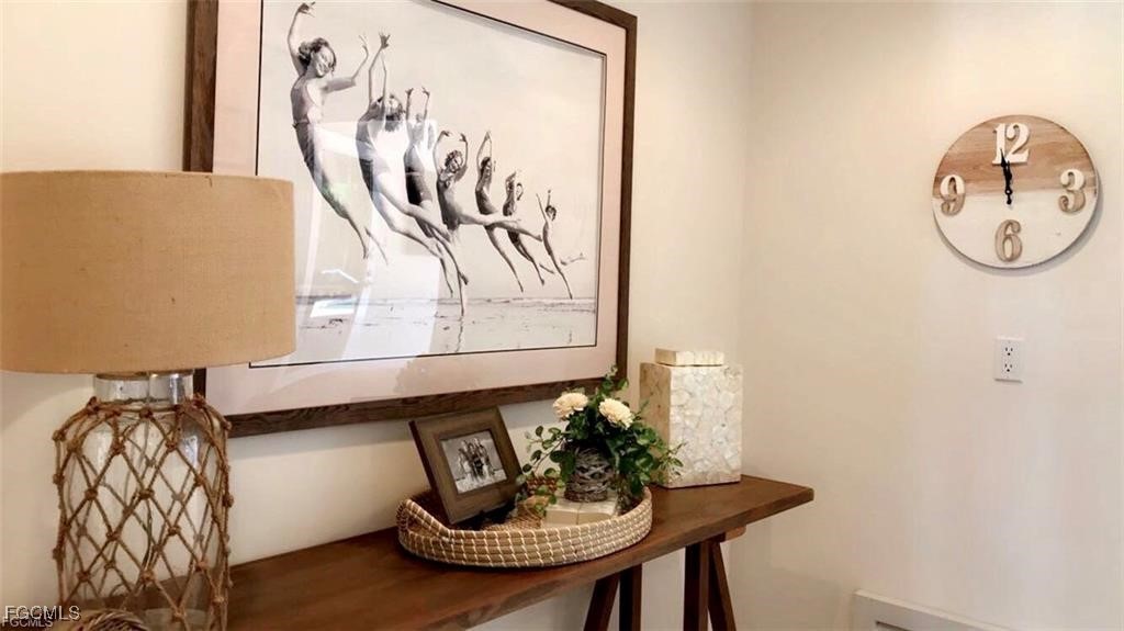 572 11th Avenue South, Unit 2 Naples, FL 34102 - Photo 18 of 28 a table with a vase and flowers on it