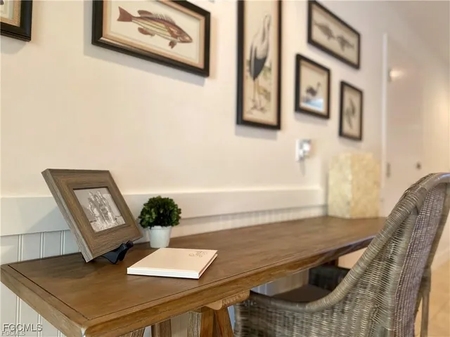a living room with furniture and painting on the wall