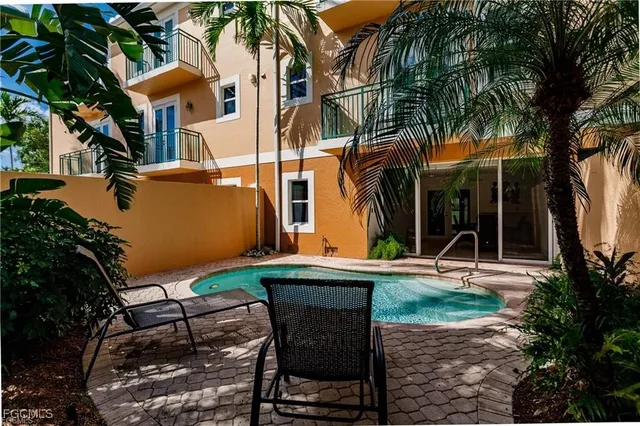 a view of backyard with outdoor seating and plants