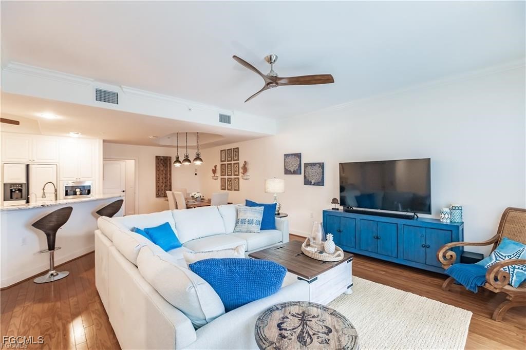 572 11th Avenue South, Unit 2 Naples, FL 34102 - Photo 5 of 28 a living room with furniture and a flat screen tv