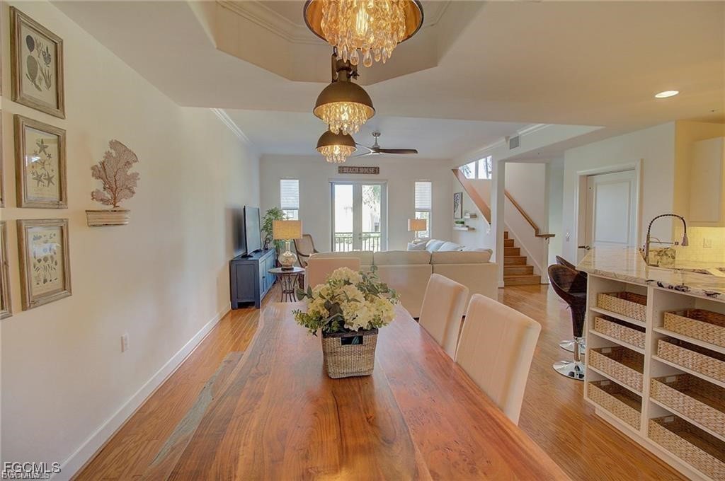 572 11th Avenue South, Unit 2 Naples, FL 34102 - Photo 6 of 28 a living room with furniture and a chandelier