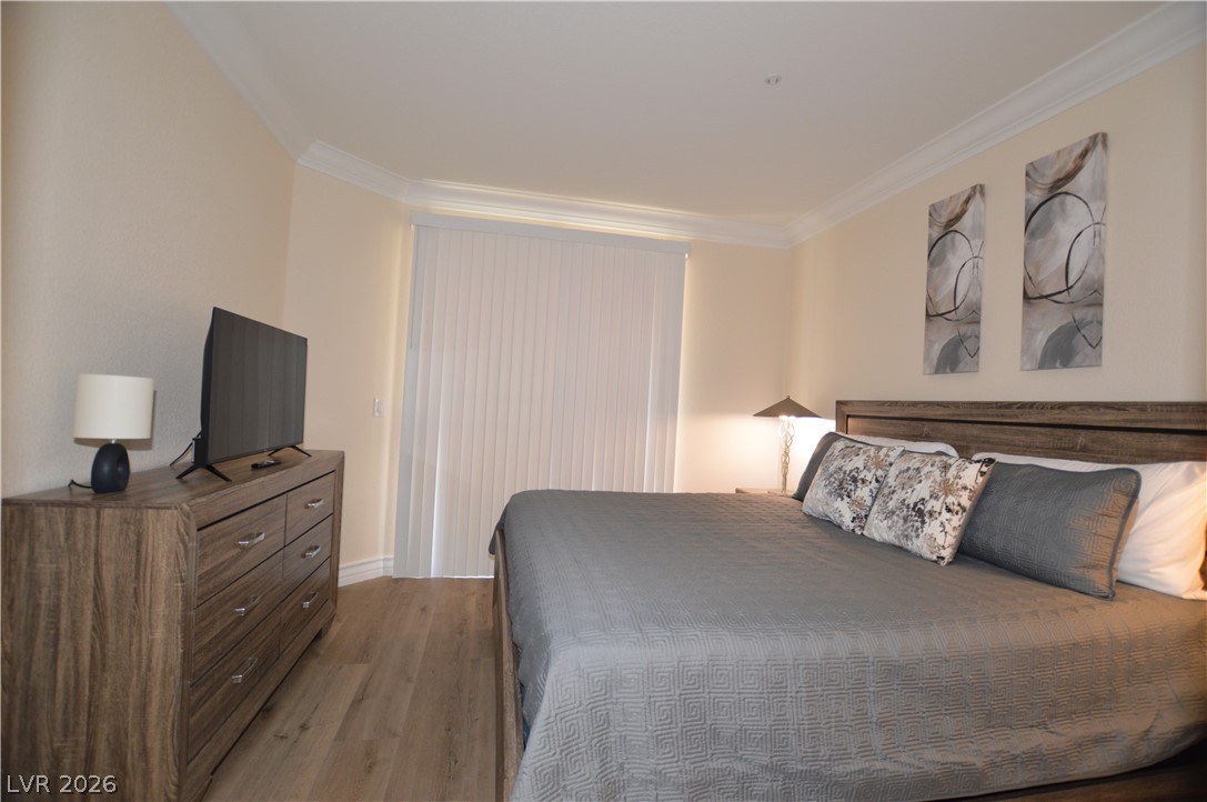 230 East Flamingo Road, Unit 334 Las Vegas, NV 89169 - Photo 8 of 37 Elegant crown molding complements warm wood-texture flooring in this comfortable sleeping space.