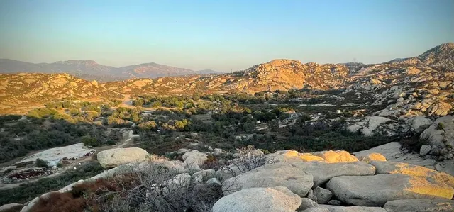 a view of a dirt road and a building