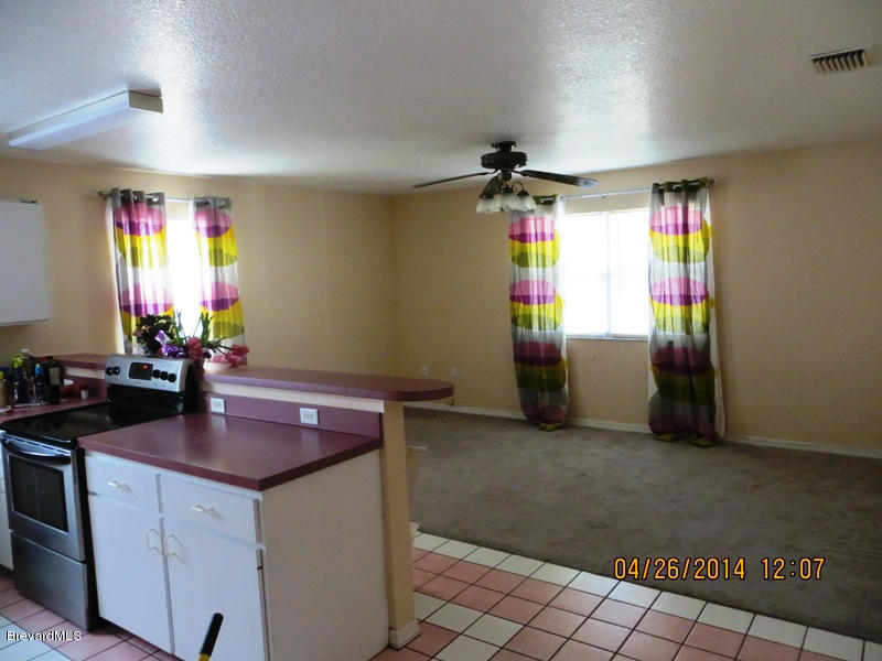 6055 Elgin Road Cocoa, FL 32927 - Photo 2 of 42 KITCHEN TO FAMILY ROOM V1